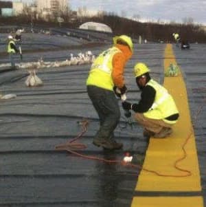 Workers installing roll traction